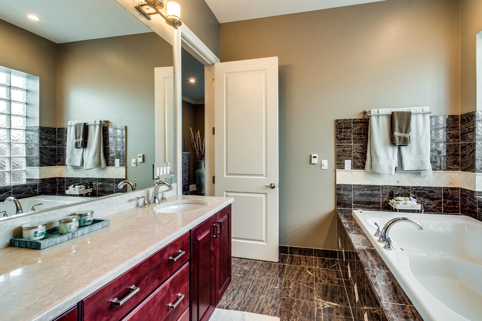 1844 West Huron Street Chicago, IL 60622 - Photo 13 of 34 a spacious bathroom with a double vanity sink a mirror and a bathtub