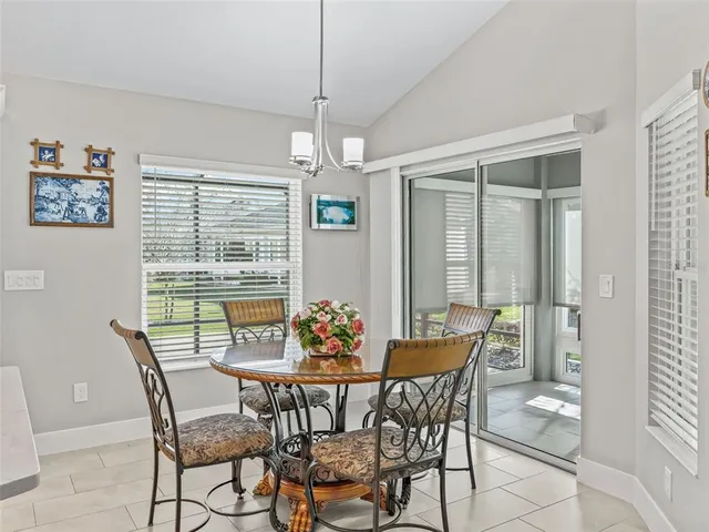 a kitchen with stainless steel appliances kitchen island granite countertop a sink a stove a refrigerator and white cabinets