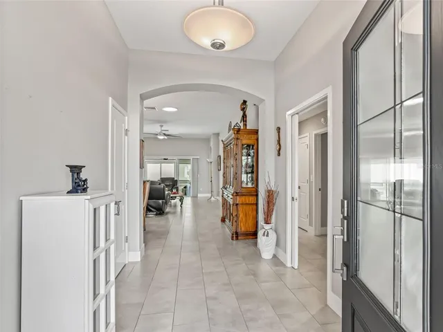 a dining room filled chandelier and wooden furniture