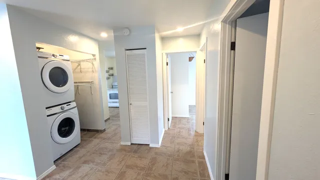 a view of a hallway with washer and dryer
