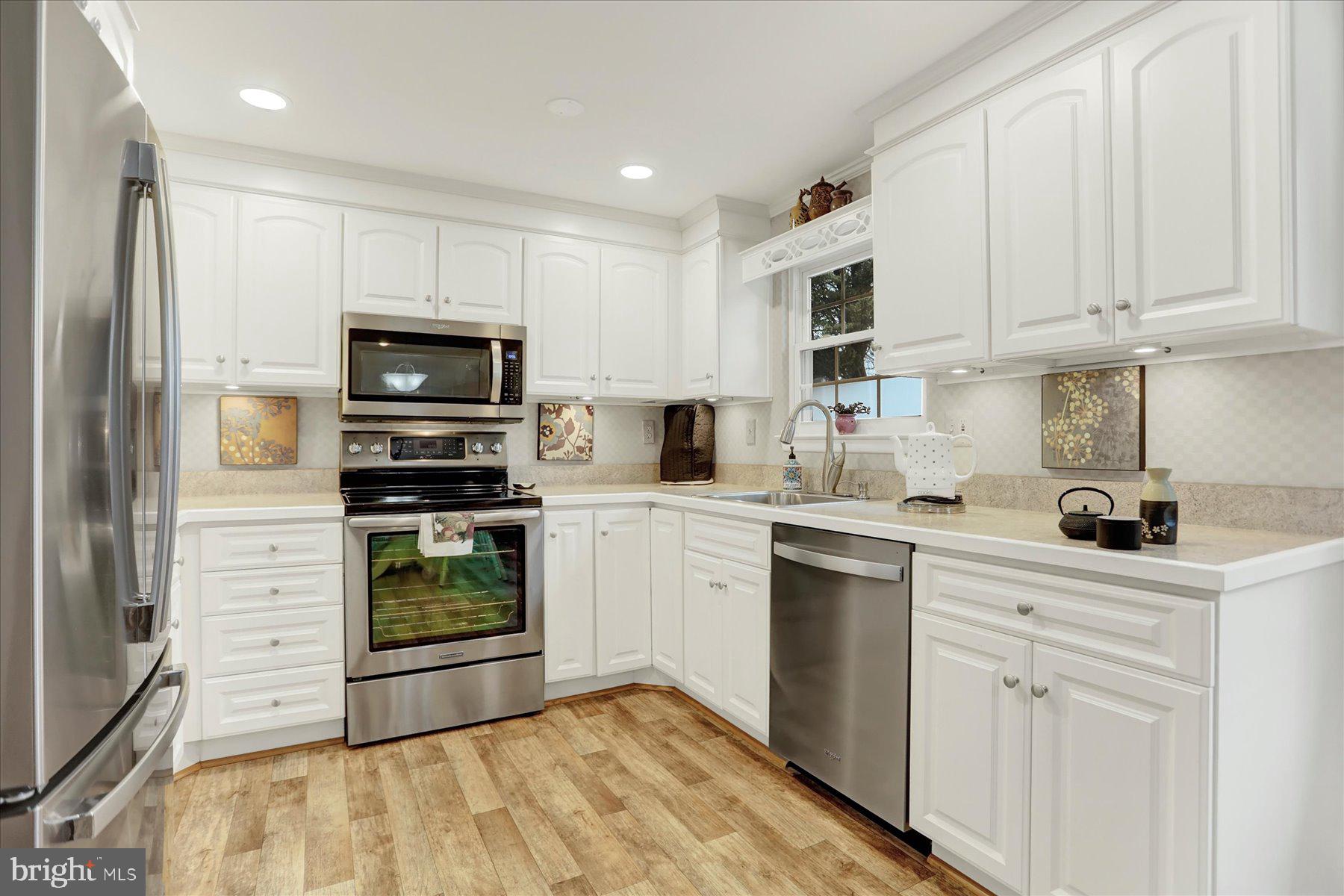 9228 Bowline Road Baltimore, MD 21236 - Photo 11 of 48 a kitchen with white cabinets and appliances