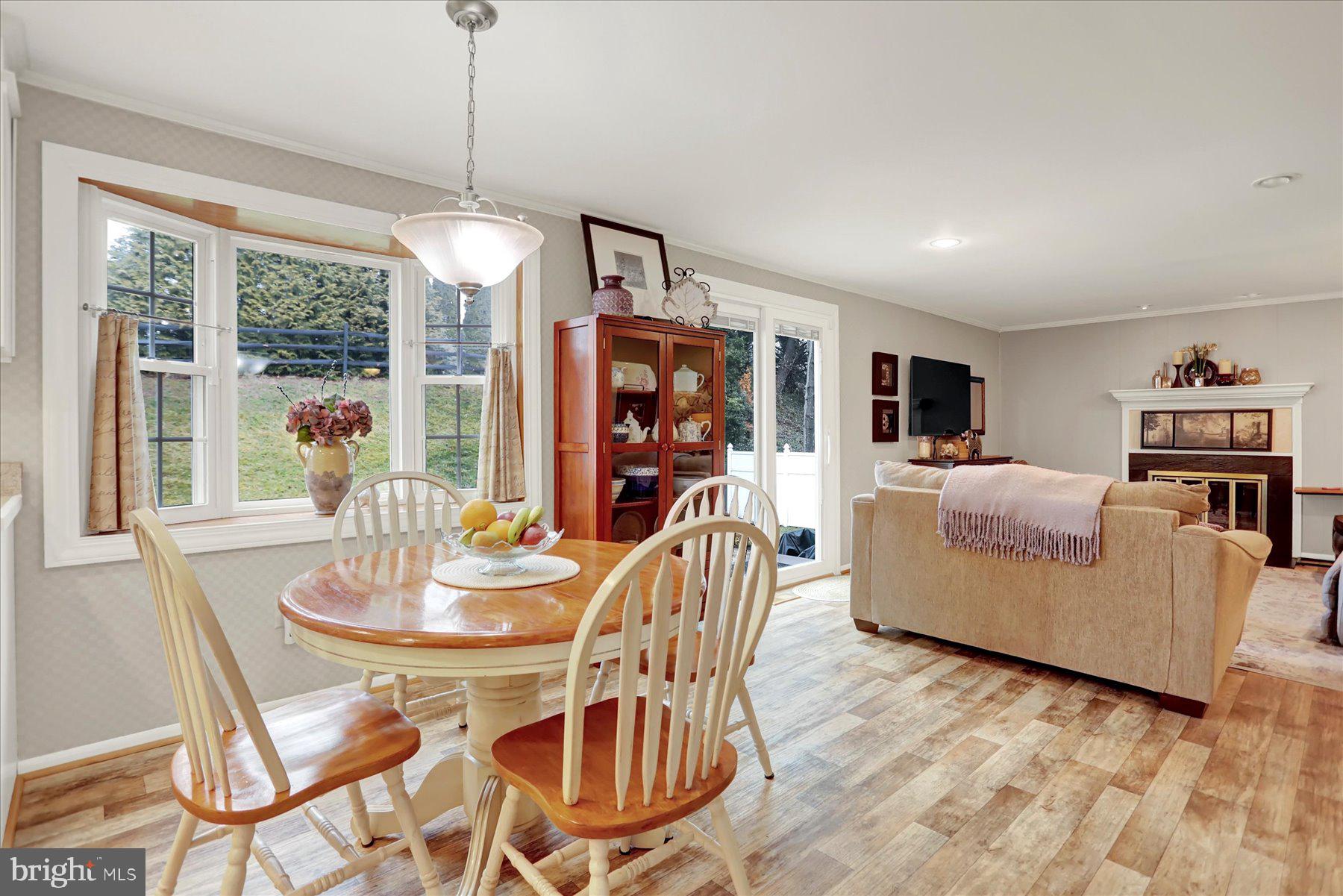 9228 Bowline Road Baltimore, MD 21236 - Photo 14 of 48 a dining room with furniture a chandelier and wooden floor
