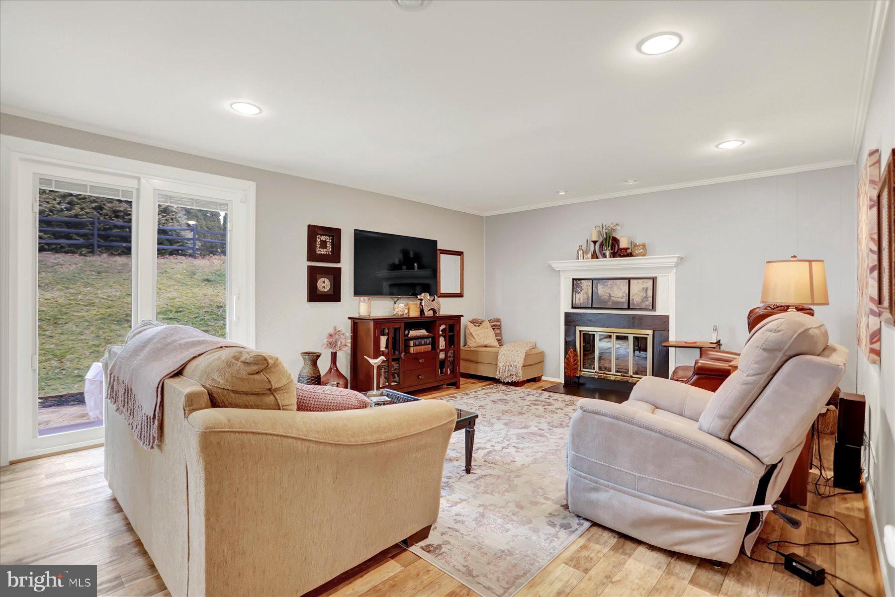 9228 Bowline Road Baltimore, MD 21236 - Photo 16 of 48 a living room with furniture a flat screen tv and a large window
