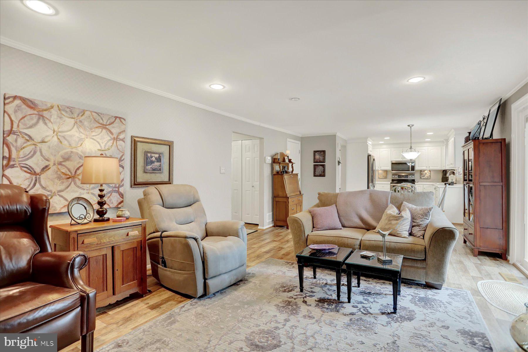 9228 Bowline Road Baltimore, MD 21236 - Photo 18 of 48 a living room with furniture a refrigerator and a couch