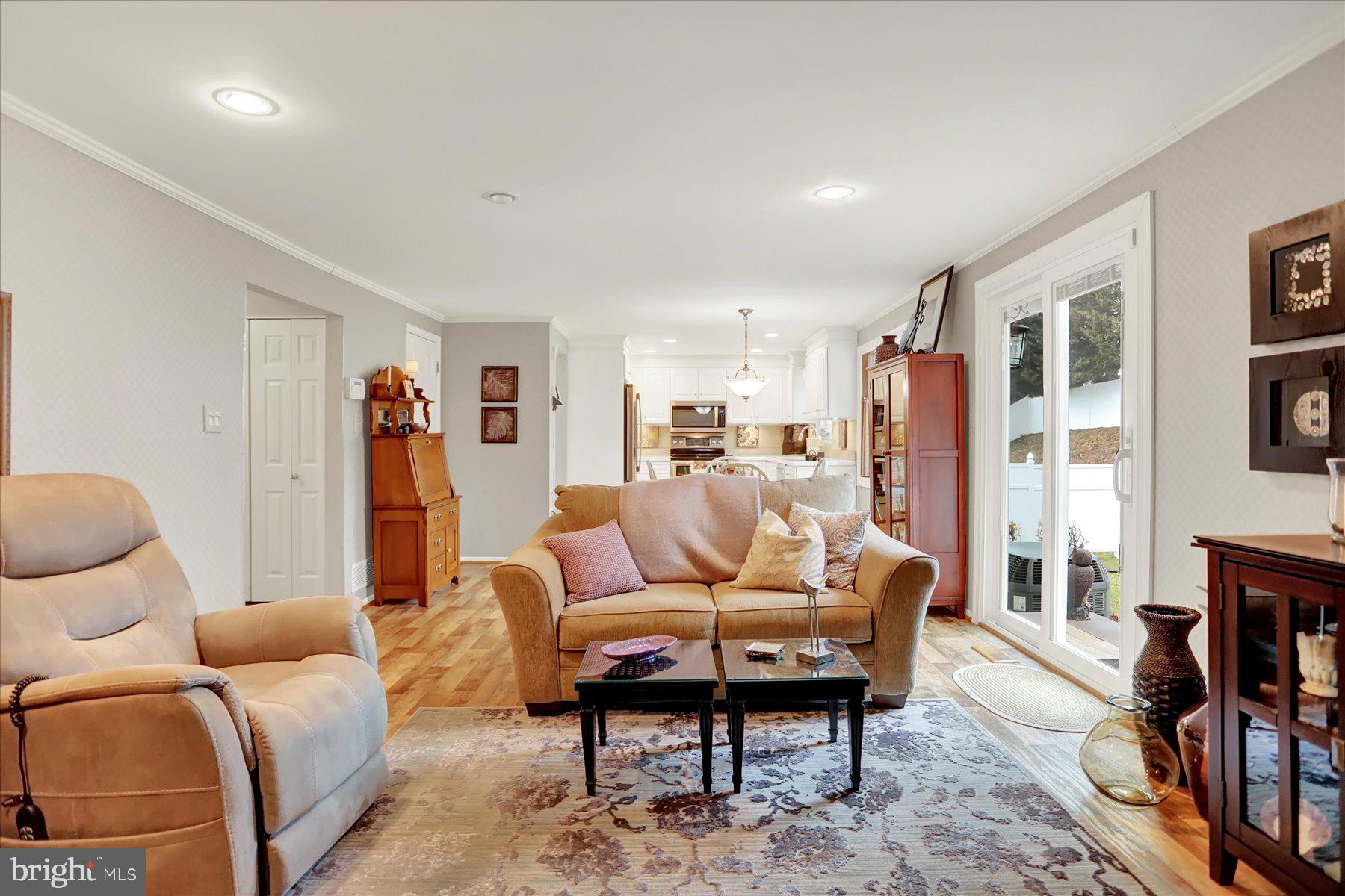 9228 Bowline Road Baltimore, MD 21236 - Photo 19 of 48 a living room with furniture and a coffee table with bookshelf