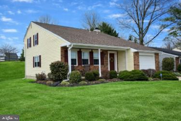 9228 Bowline Road Baltimore, MD 21236 - Photo 2 of 48 a front view of a house with a garden and yard