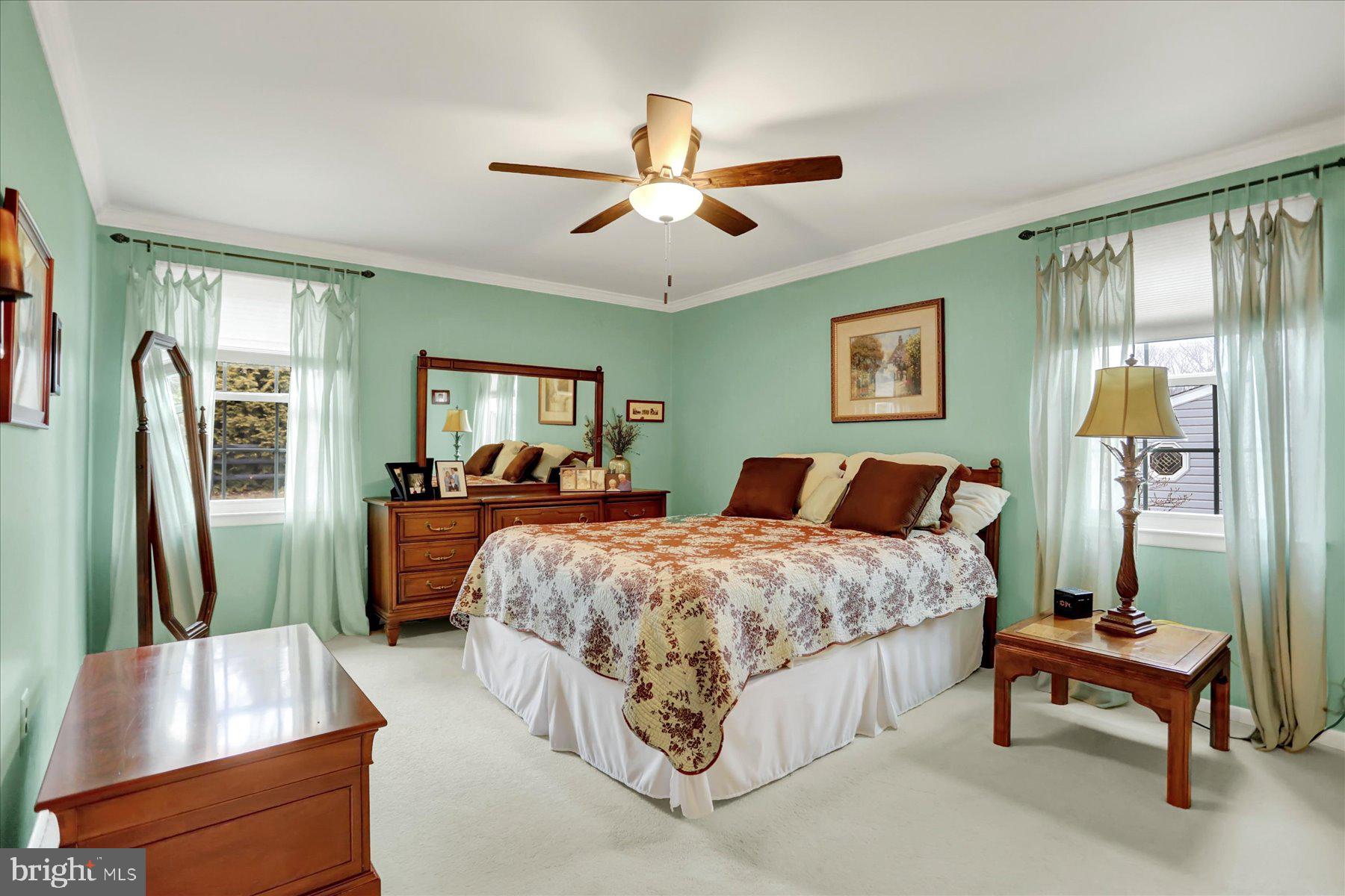 9228 Bowline Road Baltimore, MD 21236 - Photo 23 of 48 a spacious bedroom with a bed and a chandelier