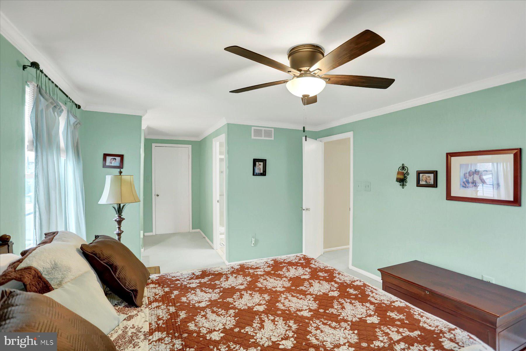 9228 Bowline Road Baltimore, MD 21236 - Photo 24 of 48 a bedroom with a large bed and a chandelier