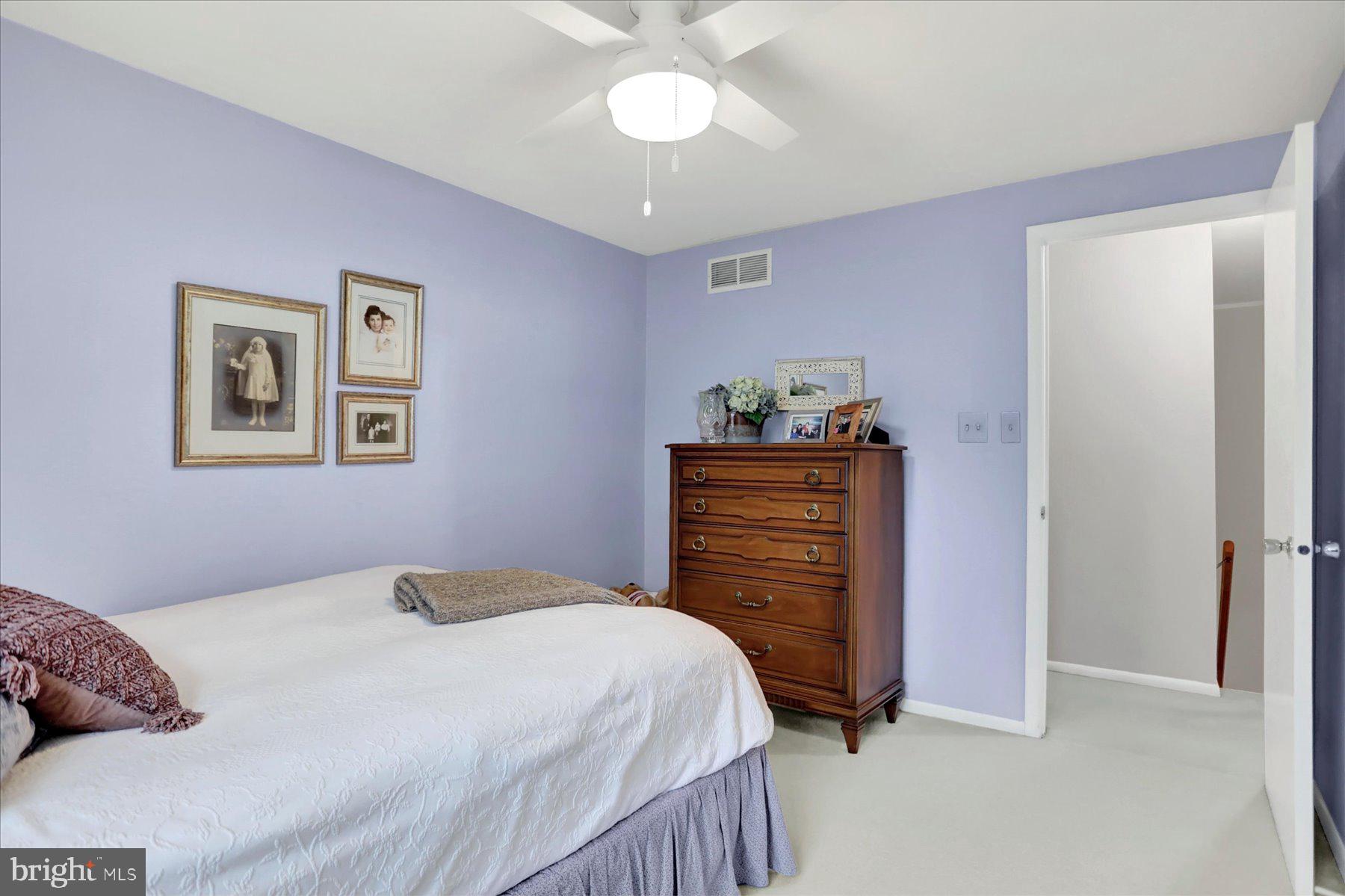 9228 Bowline Road Baltimore, MD 21236 - Photo 32 of 48 a bedroom with a bed and a chandelier