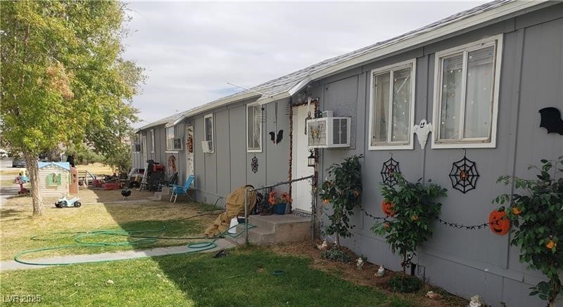 View of property exterior featuring a lawn