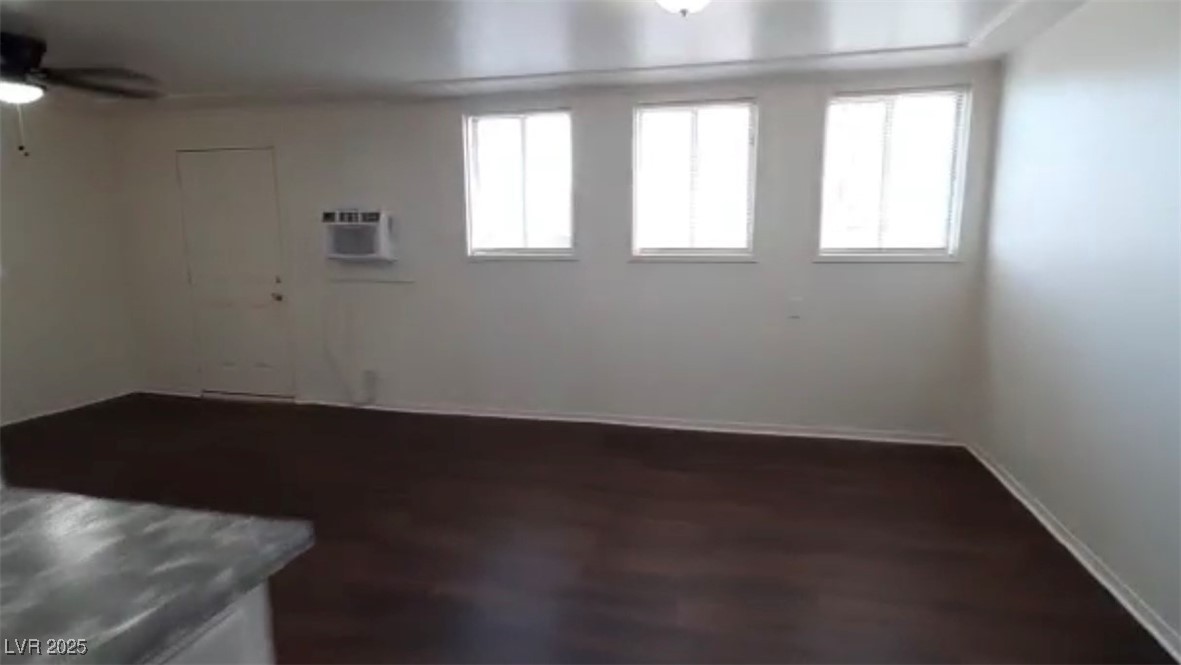 180 North Jones Street, Unit 5 Overton, NV 89040 - Photo 4 of 14 Empty room with ceiling fan and an AC wall unit