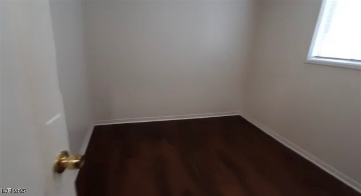 180 North Jones Street, Unit 5 Overton, NV 89040 - Photo 7 of 14 Empty room featuring baseboards and dark wood-type