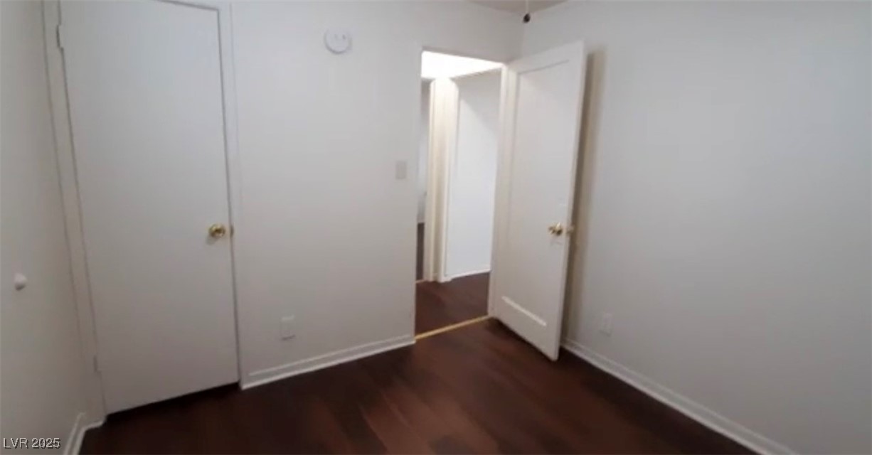 180 North Jones Street, Unit 5 Overton, NV 89040 - Photo 8 of 14 Unfurnished bedroom featuring dark wood-style floo