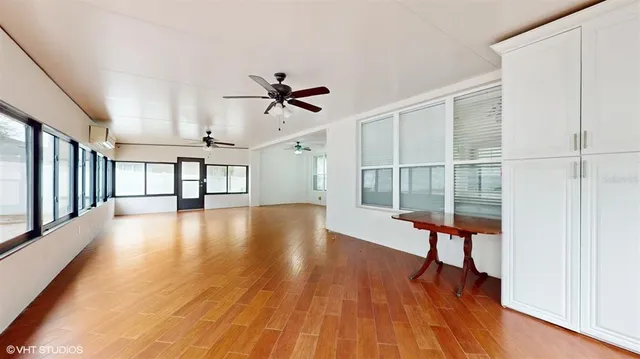 a view of workspace with wooden floor and windows