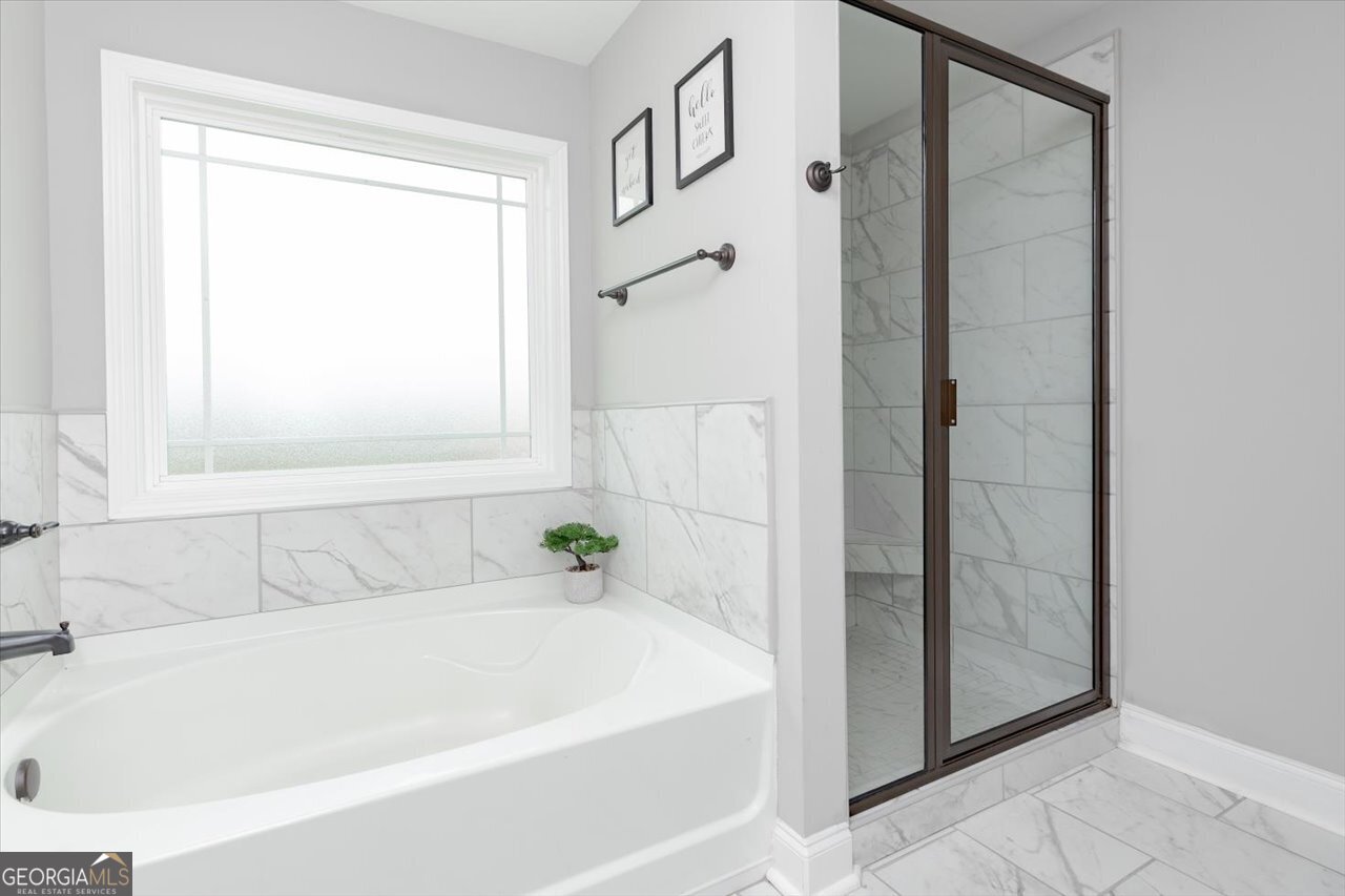 104 Meredith Layne Court Perry, GA 31069 - Photo 26 of 46 a white bath tub sitting next to a shower
