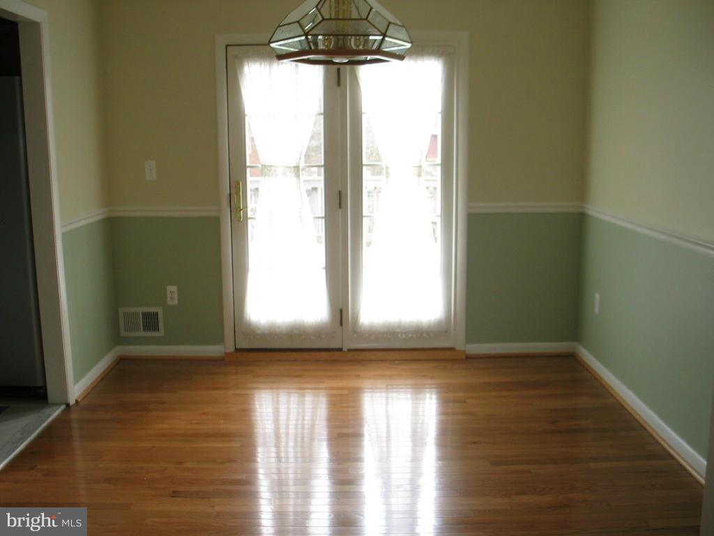841 Evergreen Road Severn, MD 21144 - Photo 11 of 26 a view of empty room with wooden floor and fan
