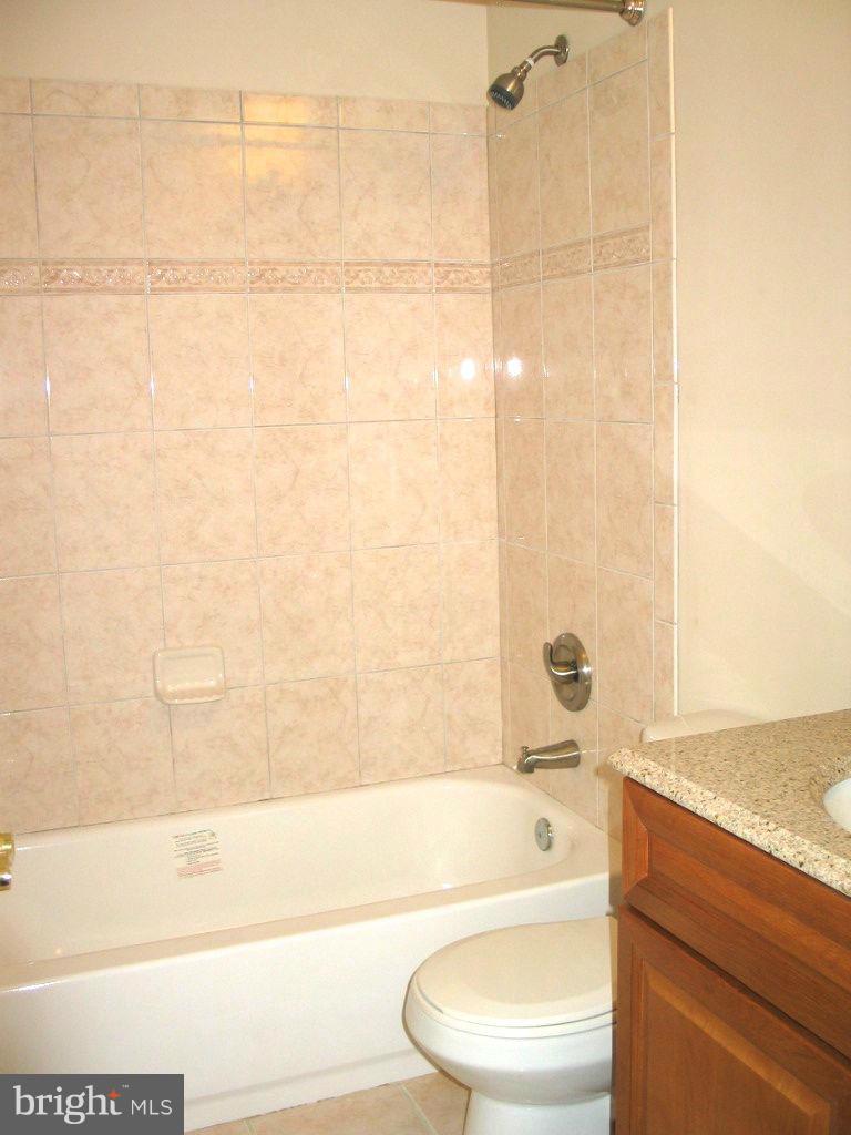 841 Evergreen Road Severn, MD 21144 - Photo 17 of 26 a bathroom with a bathtub and a sink