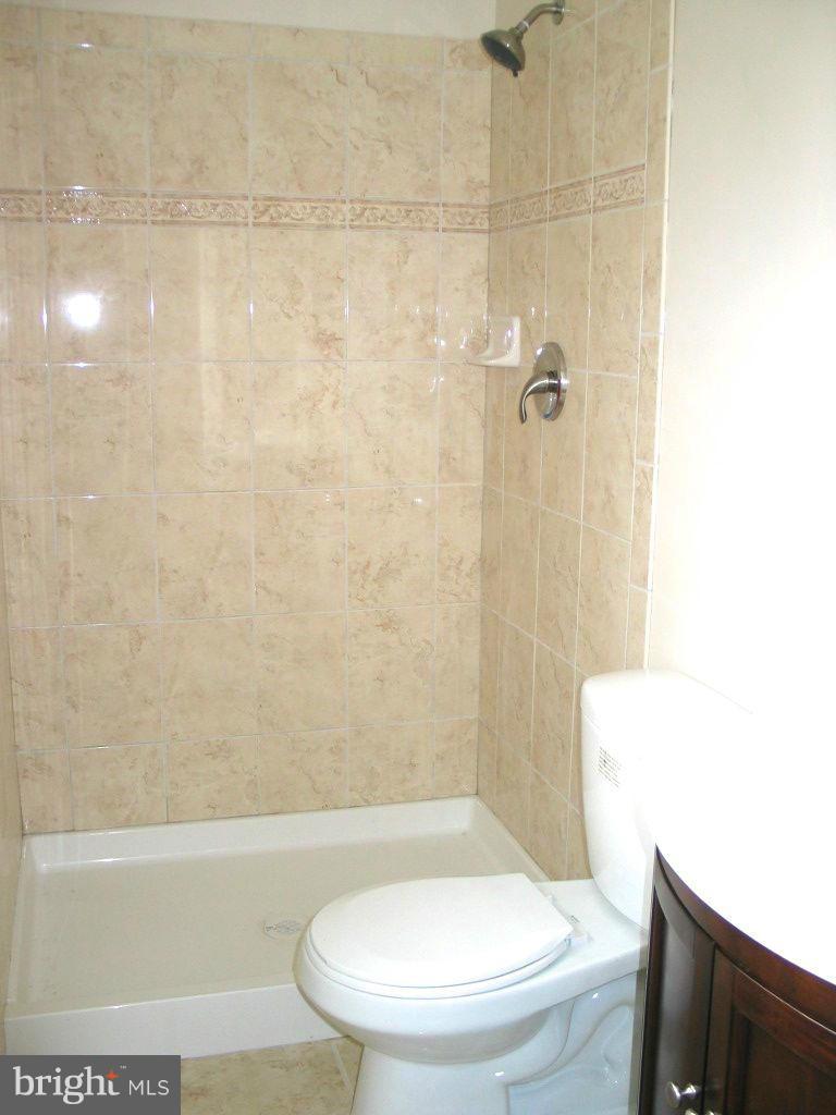 841 Evergreen Road Severn, MD 21144 - Photo 18 of 26 a bathroom with a toilet and a shower