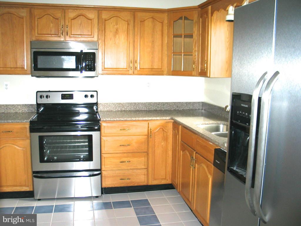841 Evergreen Road Severn, MD 21144 - Photo 6 of 26 a kitchen with a stove and a microwave