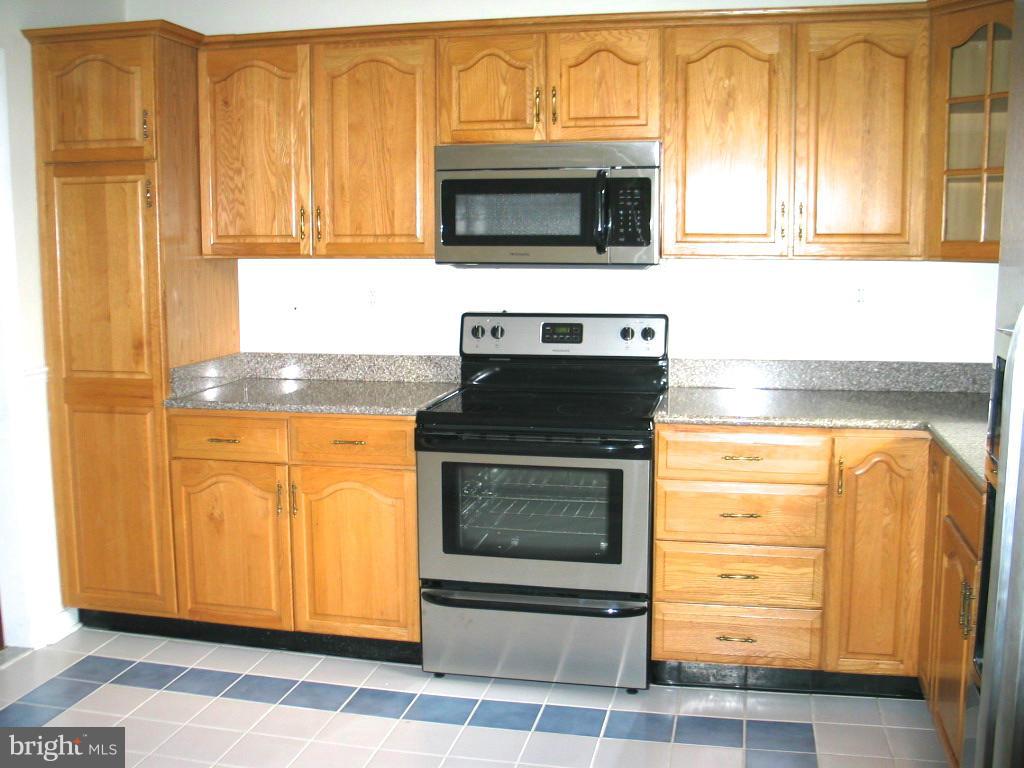 841 Evergreen Road Severn, MD 21144 - Photo 7 of 26 a kitchen with granite countertop cabinets stainless steel appliances and a counter space
