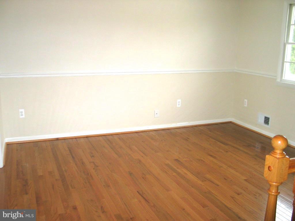 841 Evergreen Road Severn, MD 21144 - Photo 8 of 26 a view of a room with wooden floor