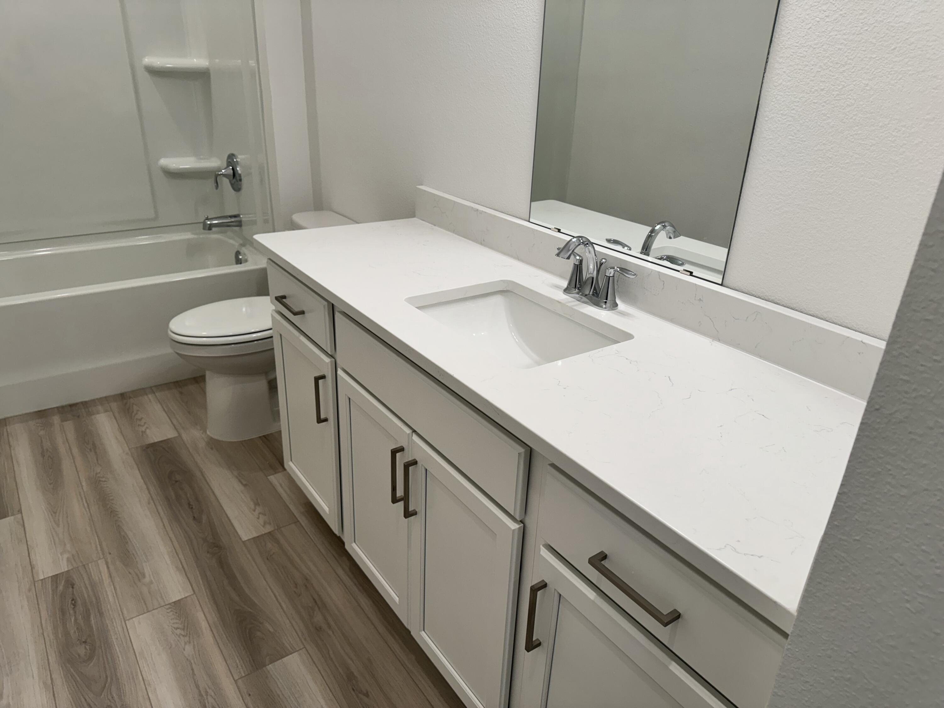 157 Blooming Cove Crestview, FL 32539 - Photo 23 of 37 a bathroom with a sink a toilet a mirror and shower