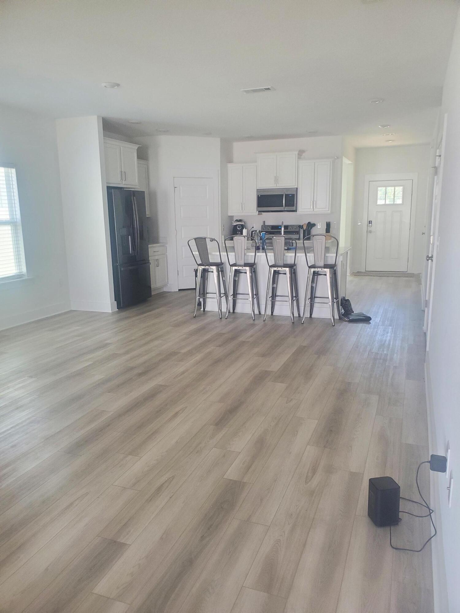 157 Blooming Cove Crestview, FL 32539 - Photo 4 of 14 a view of a kitchen with furniture and wooden floor