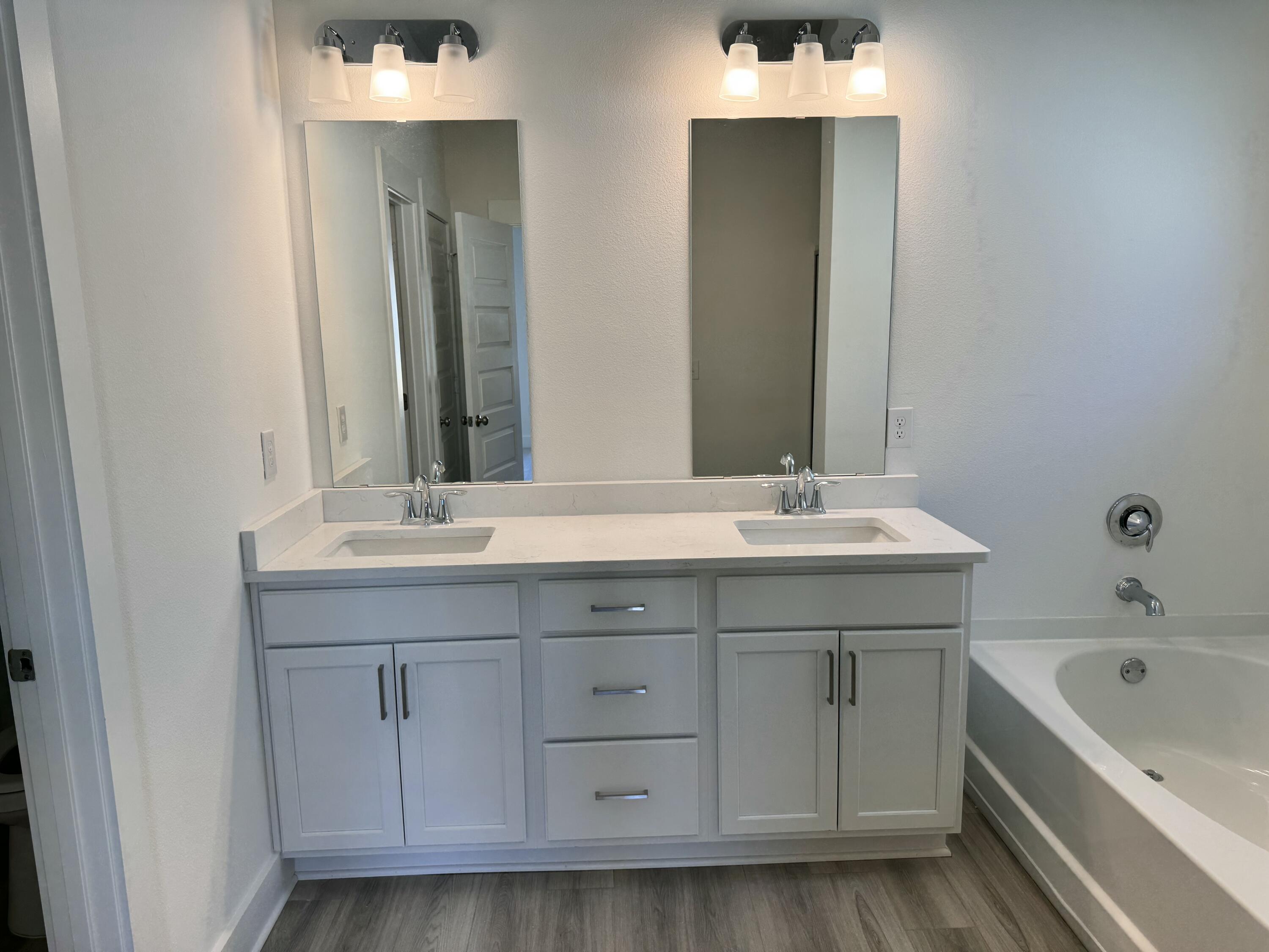 157 Blooming Cove Crestview, FL 32539 - Photo 8 of 14 a bathroom with a double vanity sink and mirror