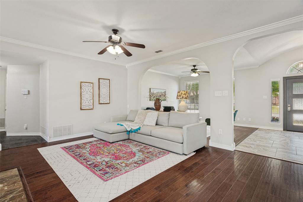1228 Concho Drive Benbrook, TX 76126 - Photo 10 of 39 Open-concept living area featuring rich wood-finish flooring, vaulted ceilings, and crown molding