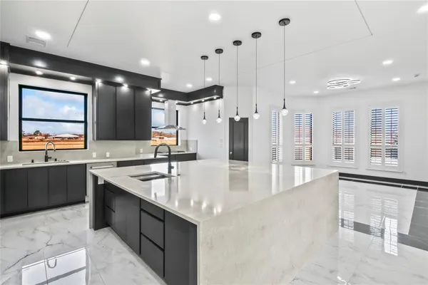 a large kitchen with a table and chairs