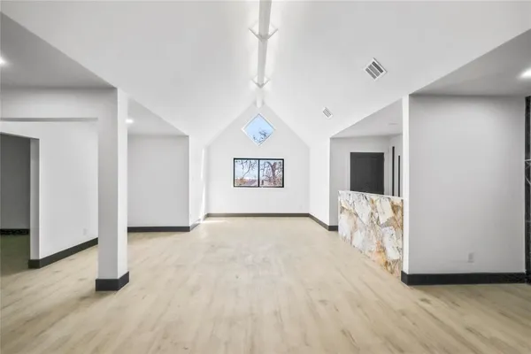 a view of room with wooden floor and window