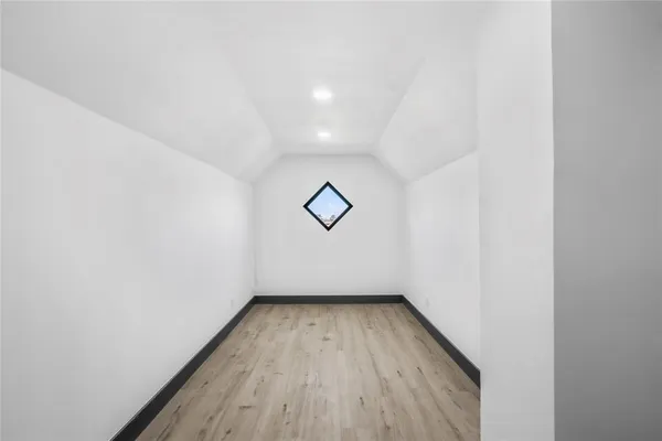 a hallway with sink and cabinets