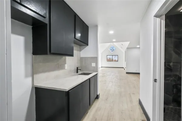 a bathroom with a granite countertop shower a toilet and a sink