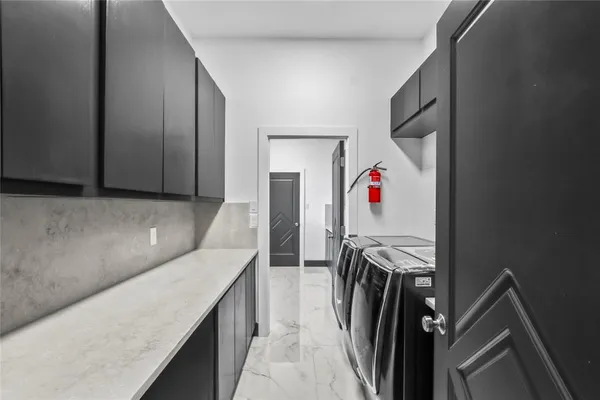 a kitchen with kitchen island sink and refrigerator