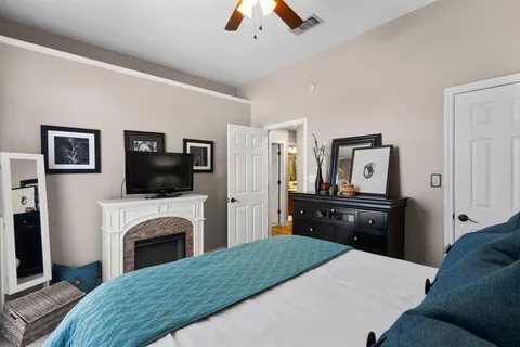 a bedroom with a bed and a fireplace