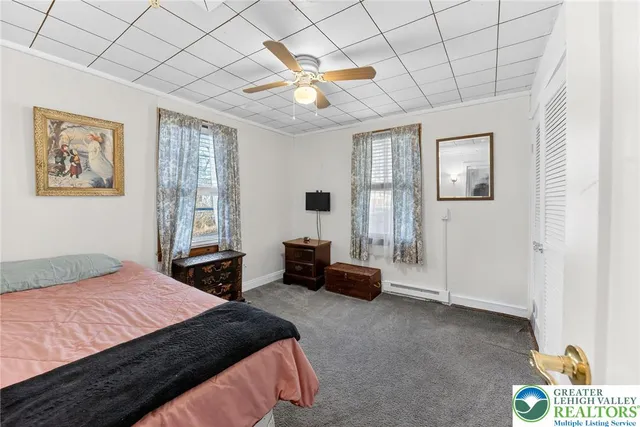 a bedroom with a bed and a couch