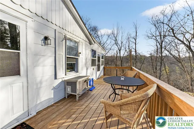 a view of a balcony with furniture and wooden floor