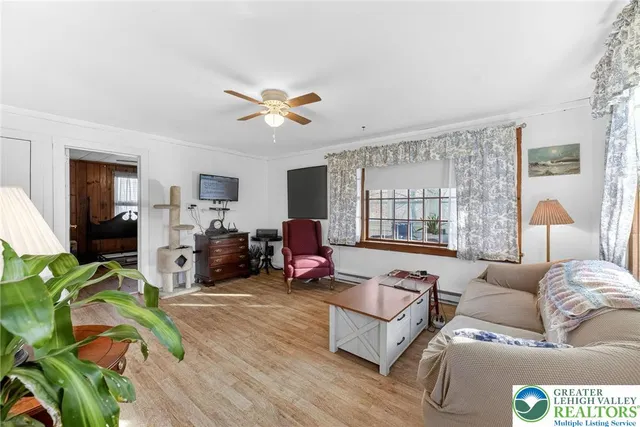 a living room with furniture fireplace and a large window