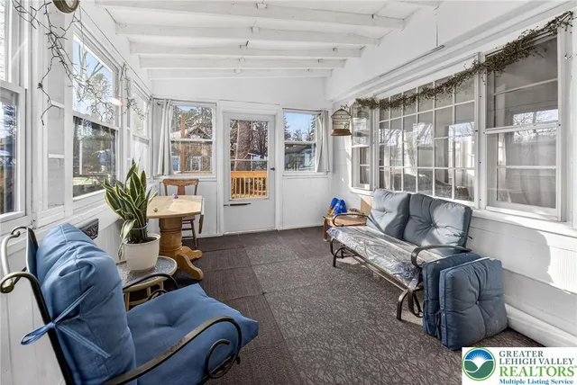 a living room with furniture and a floor to ceiling window