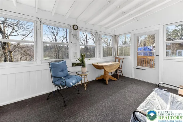 a living room with furniture and a floor to ceiling window