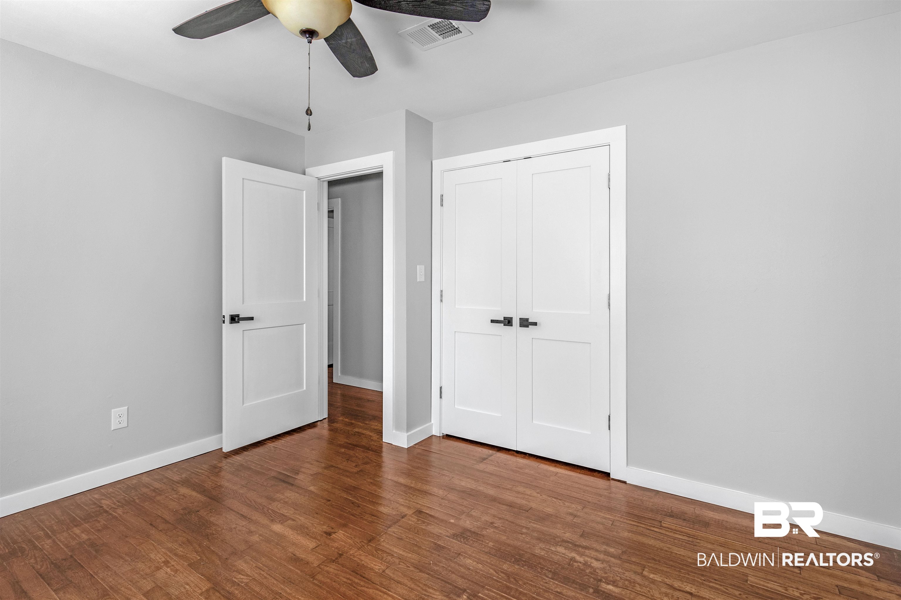 3005 Club House Road Mobile, AL 36605 - Photo 16 of 20 Unfurnished bedroom featuring a closet, hardwood / wood-style flooring, and ceiling fan