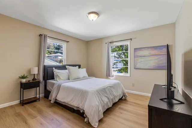 a view of room with wooden floor and fan