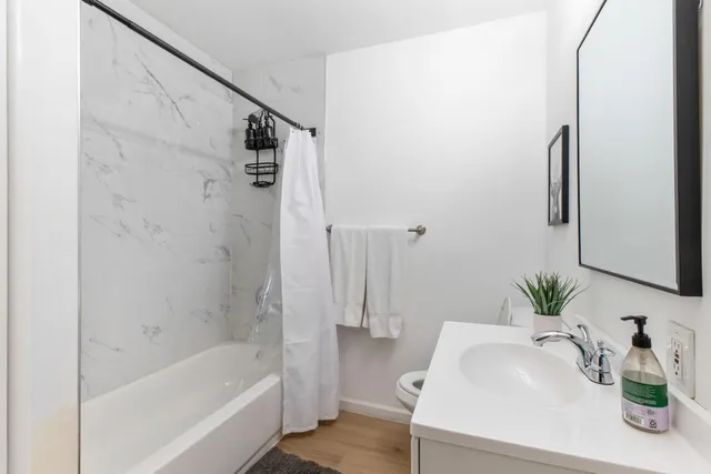 a bedroom with a bed and a painting on the wall