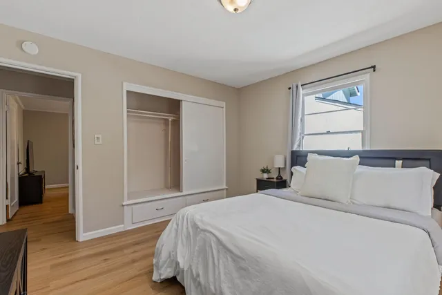 a bedroom with a bed and a flat screen tv