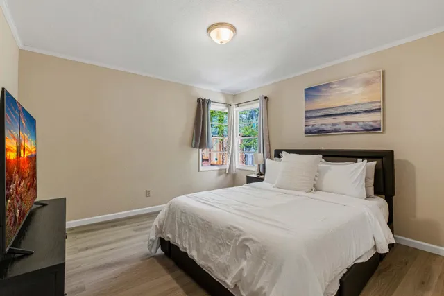 a bedroom with a bed and a night stand