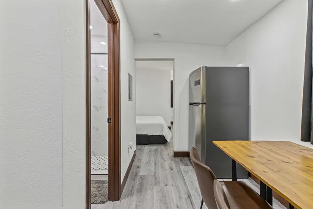 a bathroom with a sink a toilet a mirror a vanity and shower