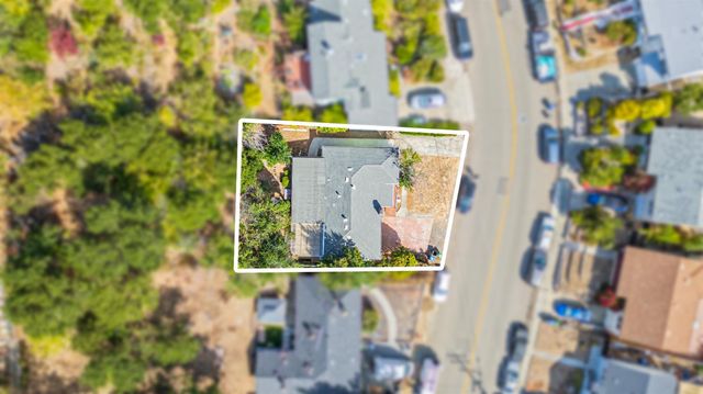 an aerial view of a house with a swimming pool