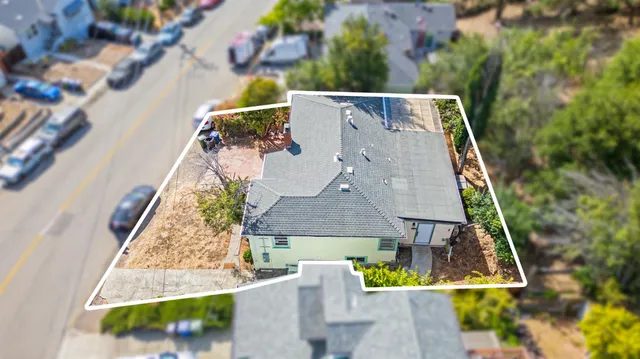 an aerial view of a house with a swimming pool
