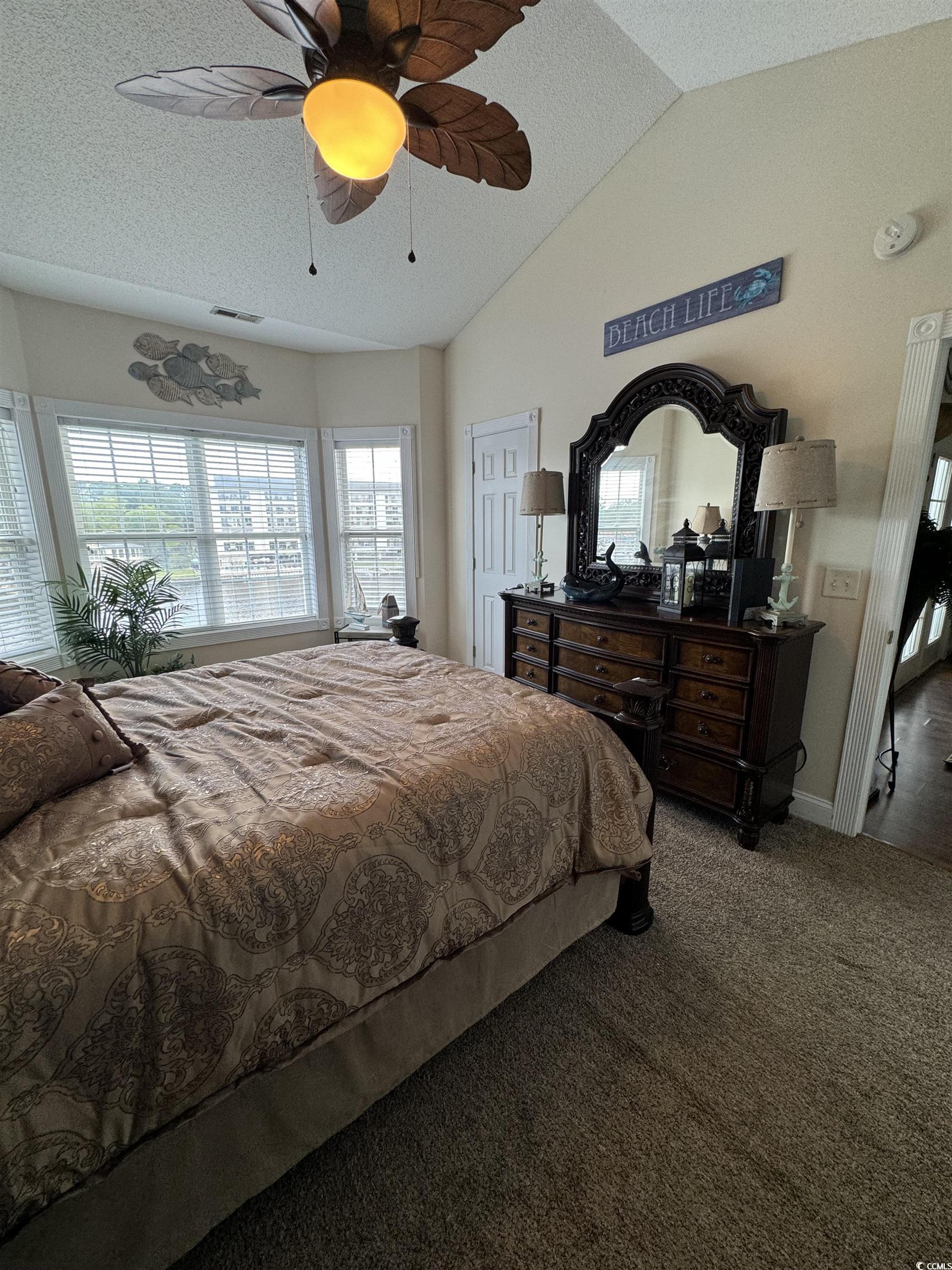 1538 Lanterns Rest Road, Unit 303 Myrtle Beach, SC 29579 - Photo 15 of 23 Bedroom with vaulted ceiling, carpet flooring, a t
