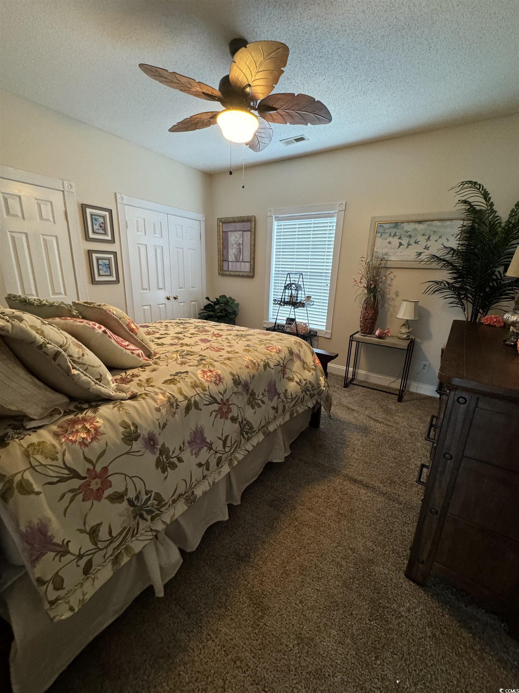 1538 Lanterns Rest Road, Unit 303 Myrtle Beach, SC 29579 - Photo 7 of 23 Bedroom featuring ceiling fan, a textured ceiling,